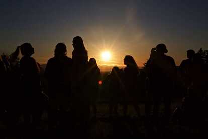 Picture silhouette of students watching sunrise